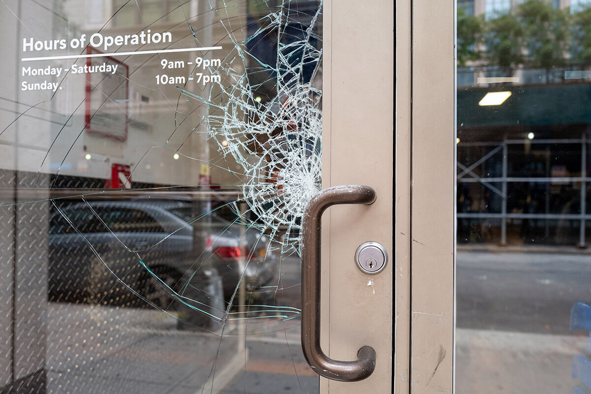 broken shattered window on store front door